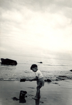 John digging for gold on a beach in 1955